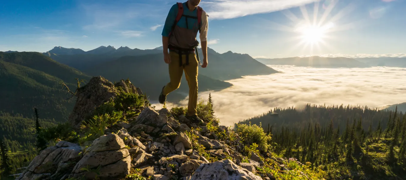 Kyle Hamilton hiking mountain top sun over valley