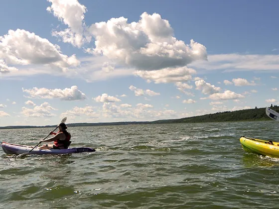A family kayaks on the lake in MD Bonnyville