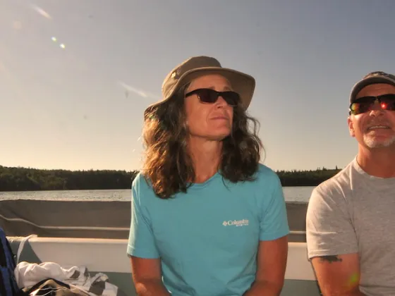 A couple in the sun on a boat in Cold Lake