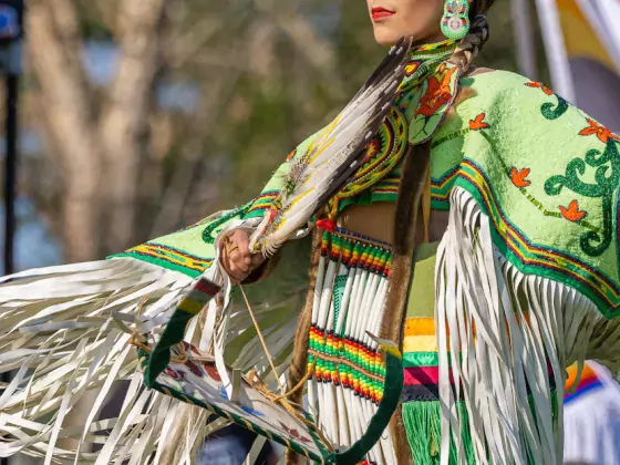 Indigenous dancer in front of Canadian Flag