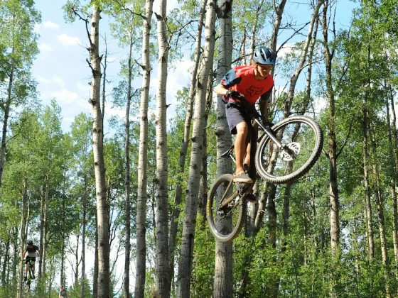 Riders taking air at the Whitecourt Bike Park, Whitecourt, AB.