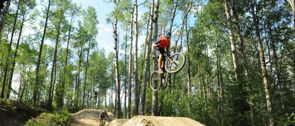 Riders taking air at the Whitecourt Bike Park, Whitecourt, AB.