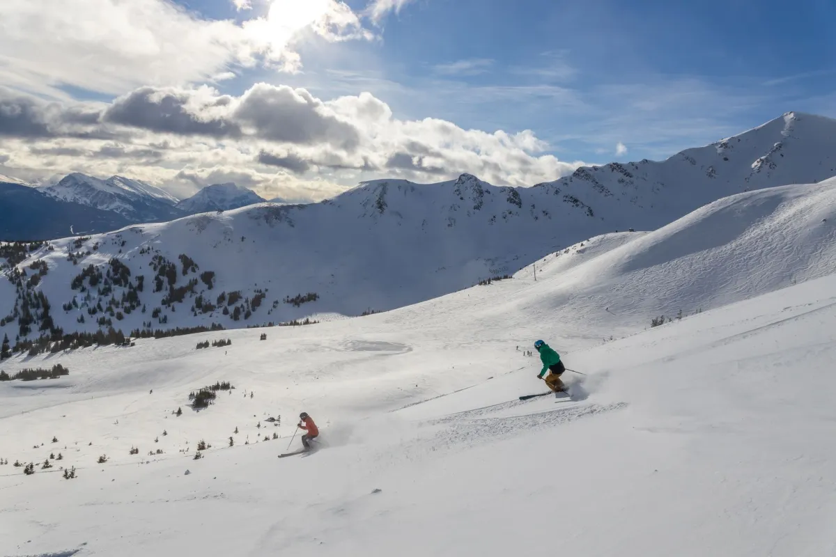 Two skiers coming down the mountain at Marmot Basin