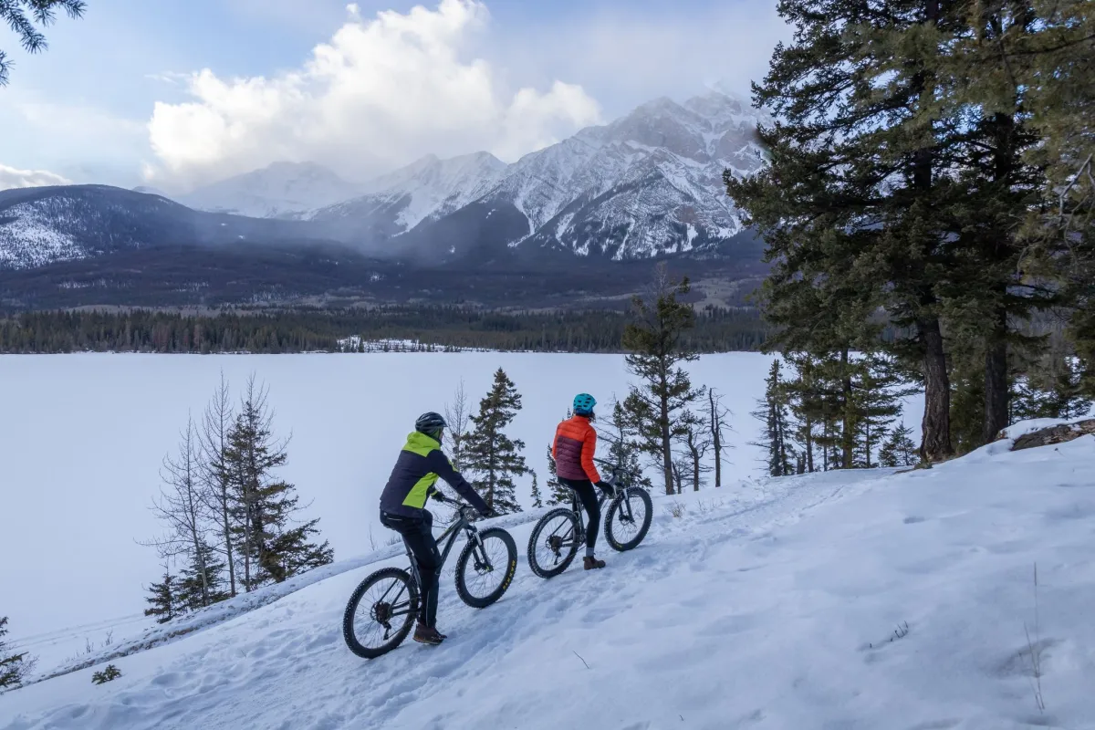 Two people fatbiking around Pyramid Lake in Jasper National Park