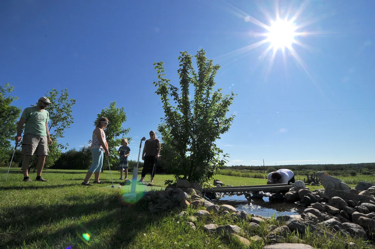 A family plays mini golf in MD Bonnyville