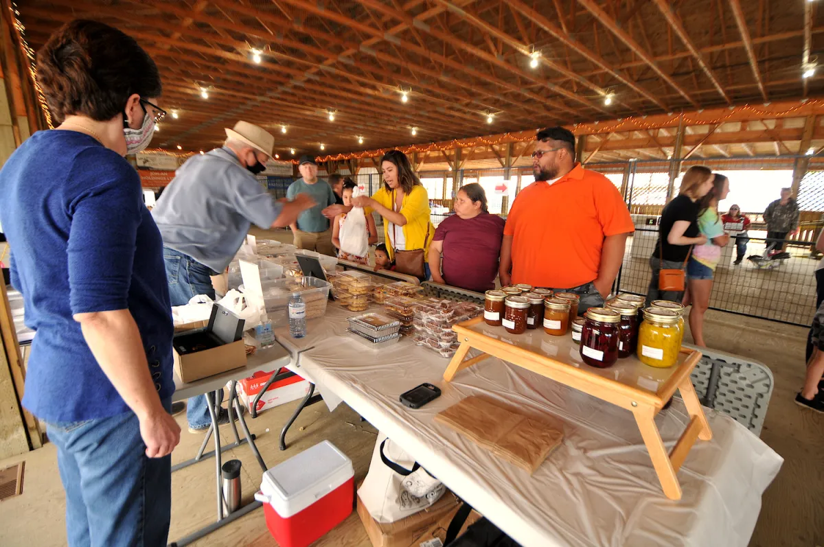 A family looks at goods for sale at Lac la Biche market