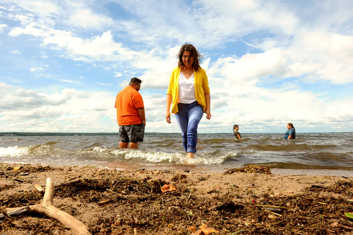 A family enjoys the beach in lac la biche