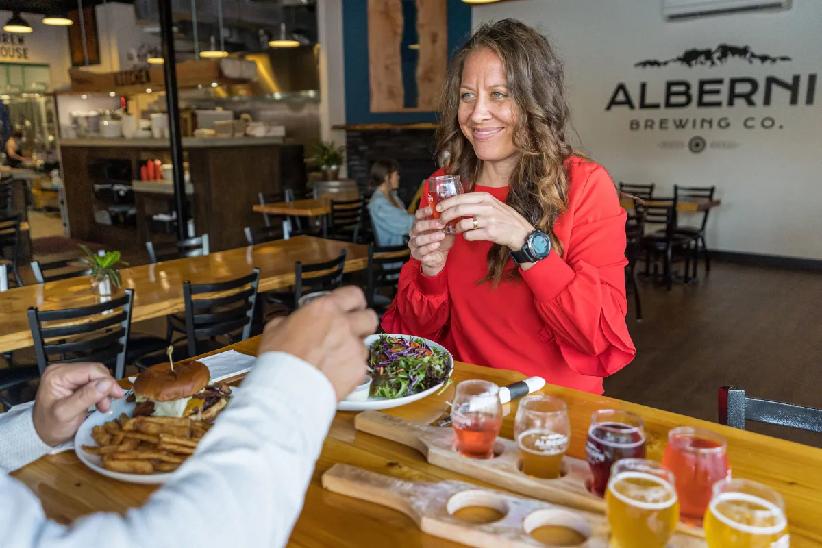 Couple enjoying sliders and flights at Alberni Brewing Co, Port Alberni, BC.