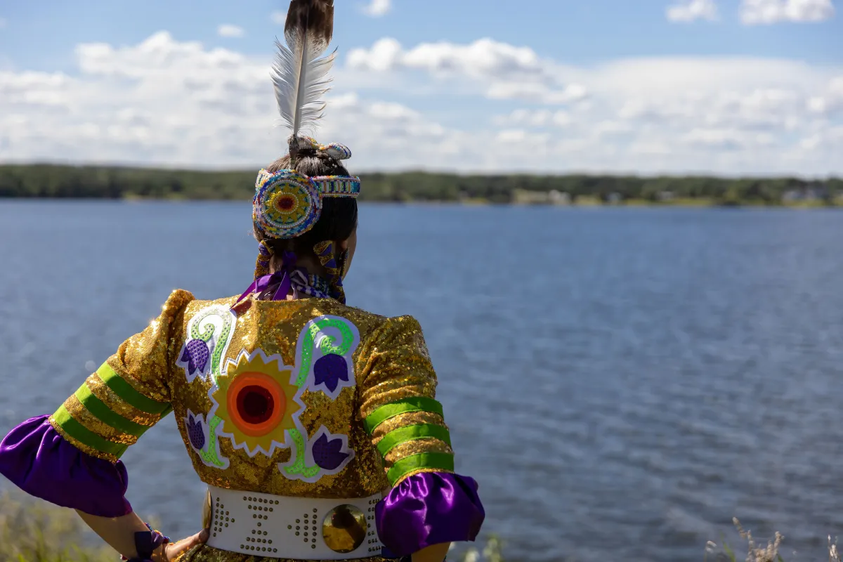 Jingle Dress dancer Randi Candline overlooks Lac La Biche, Lac La Biche, AB.