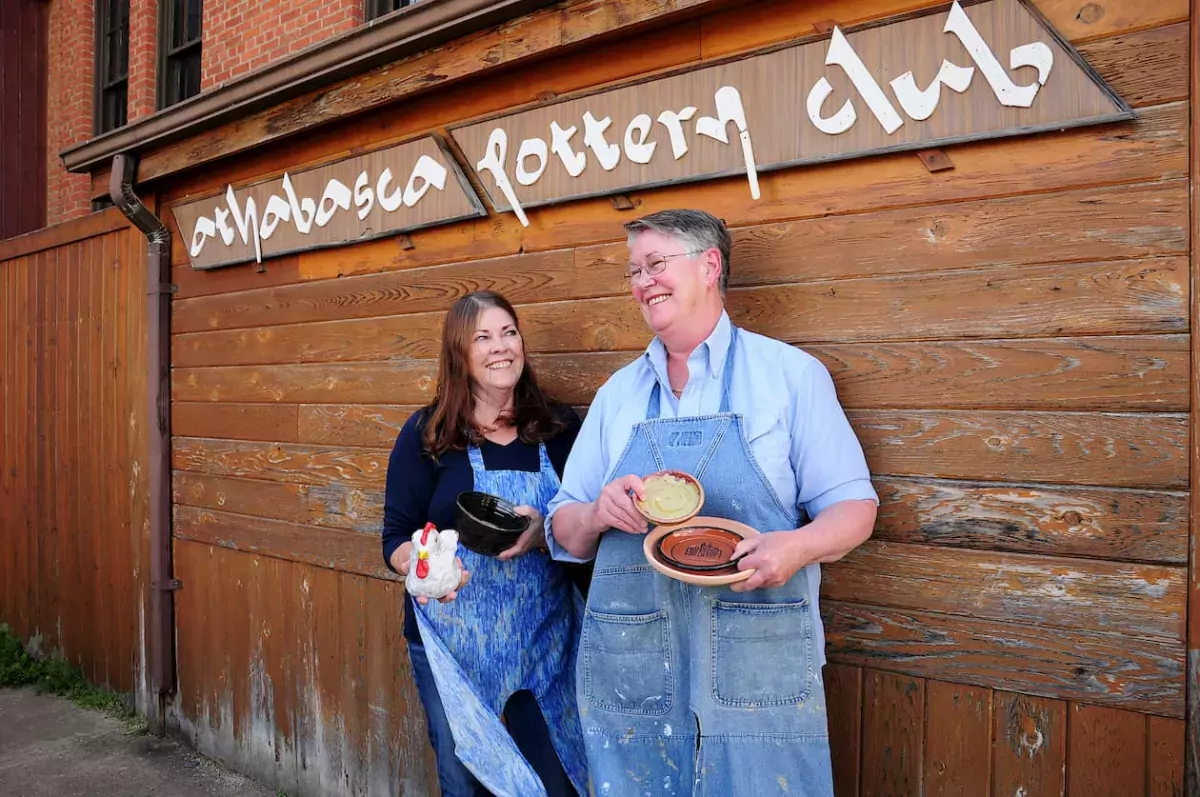 Two members of Athabasca Pottery Club stand outside