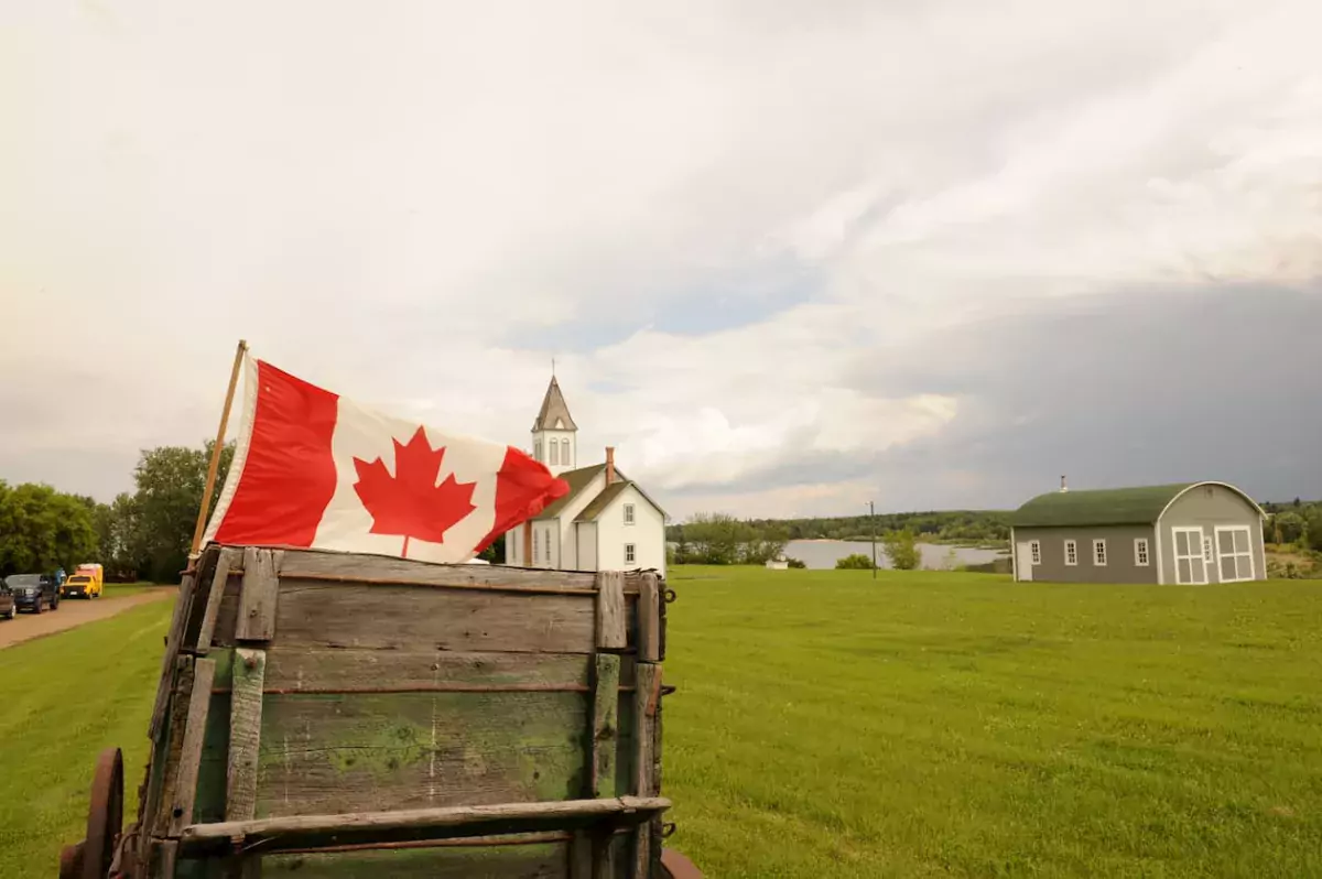 Canadian flag by Red River Cart at the Lac La Biche Mission