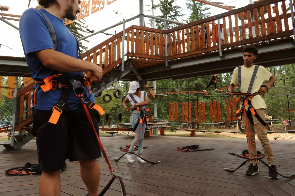 Putting on safety devices at Snow Valley Aerial Park
