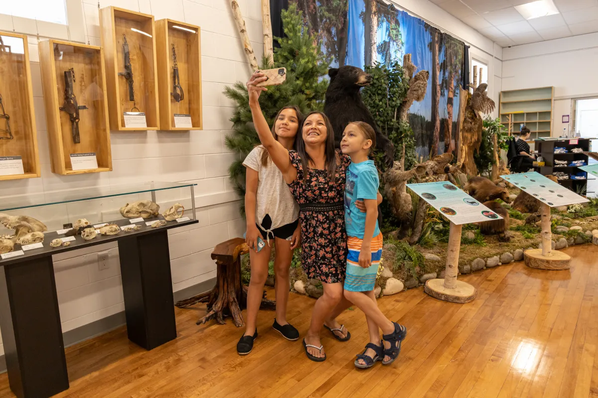 Family exploring Lac La Biche Museum, Lac La Biche AB.