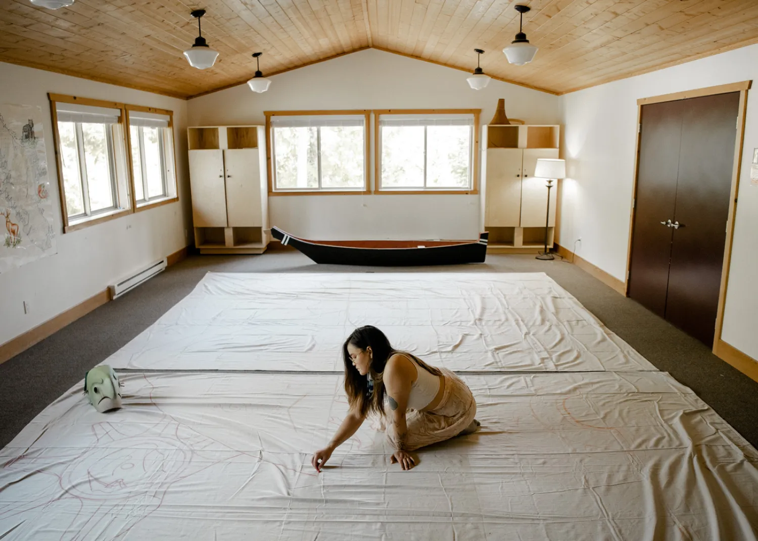 Ivy works on the large scale Tla-o-qui-aht curtains that will be on display in the Tin Wis Conference Center, one of the many highlights of the naaʔuu evenings.