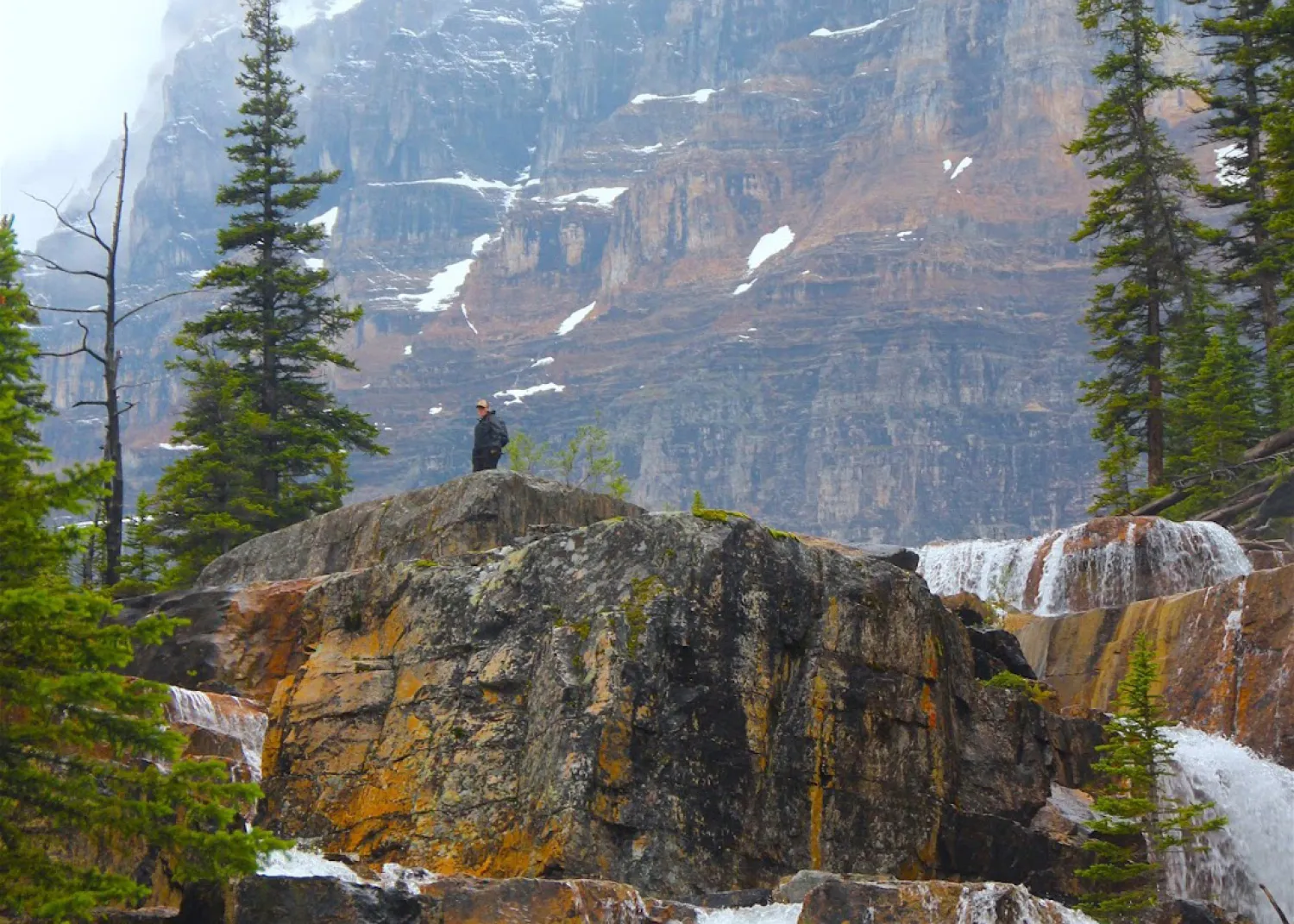 The top of Giant Steps Waterfalls in Banff National Park, with a person on top for perspective